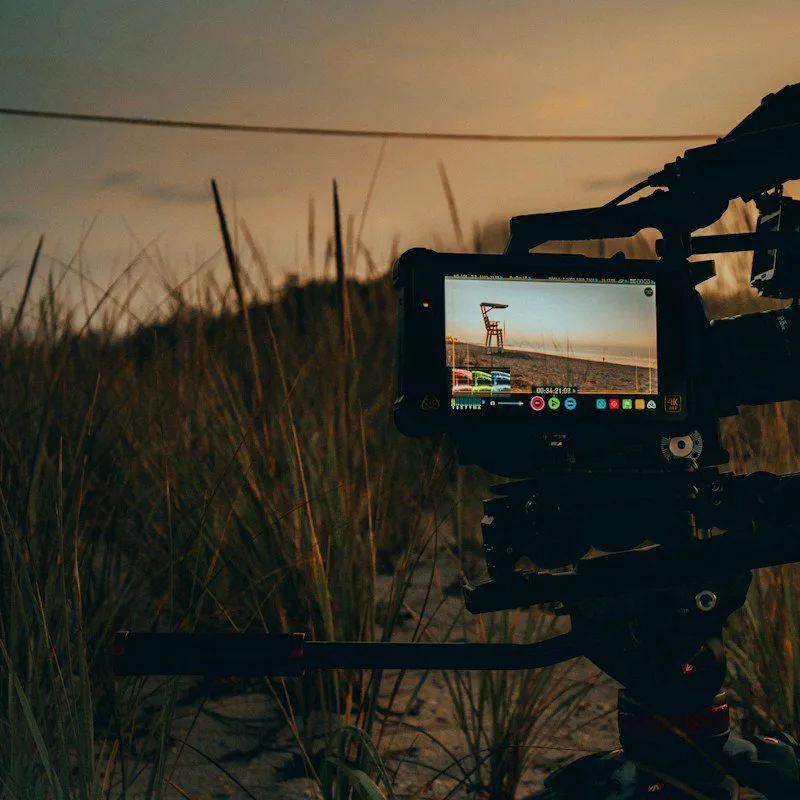 Une caméra de cinéma sur trépied au coucher du soleil